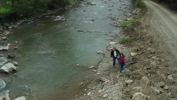 Hikers Walking River Aerial View Close Mountain Road Among Green Forest Trees alt