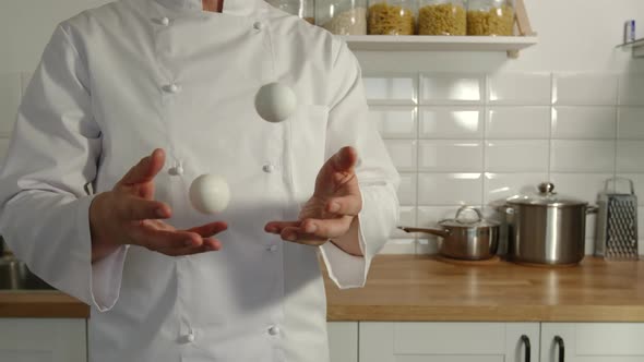 Chief-Cooker Juggles A Chicken Eggs In A Kitchen