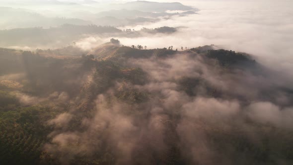 4K Aerial view from drone over mountains fog. Golden scenery at sunrise, Nan, Thailand alt