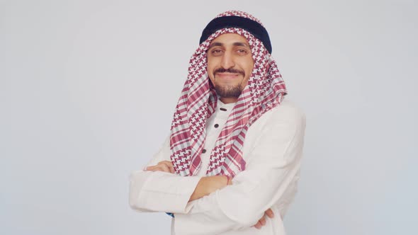 The Field of Business and Trade. A Man with a Beard and National Dress Smiling. Arab in a Modern alt
