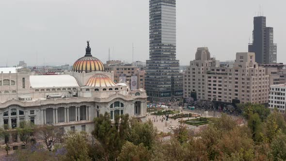 Reveal of City Ascending Drone Flying Around Colourful Dome with Bird Sculpture of Palace of Fine alt