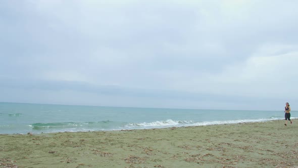 Strong Slim Woman Running Alone at Seaside. Diet and Sport for Healthy Life alt