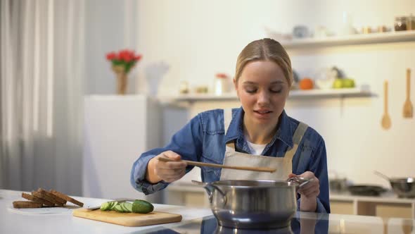 Girl Disgusted With Stinky Meal on Stove alt
