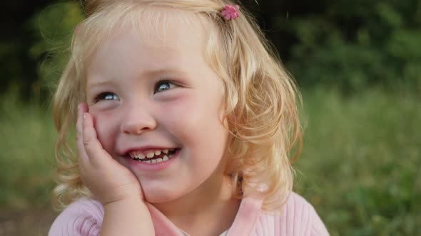 Little Girl 2 Years Old Cute Smiling Looking To the Side alt