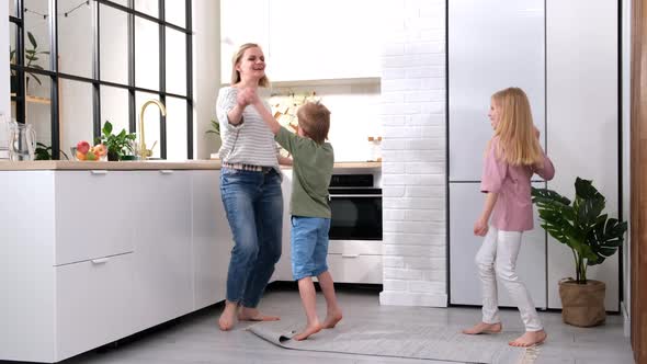 Excited Mom or Babysiter and Two Kids Boy and Girl Jumping Dancing Laughing in Modern Scandinavian alt