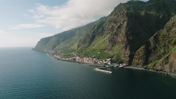 Coastal town at bottom of precipitous cliffs, Paul do Mar, Madeira; aerial alt