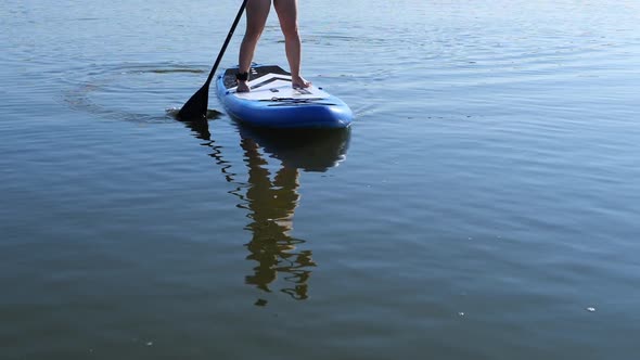 Woman  On Sup Surf Swimming. Watersport Floating Surfboard Sport Recreation