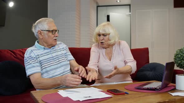 Senior Couple Checking Papers, Domestic Bills, Planning Budget Investment Loan Insurance Payment alt