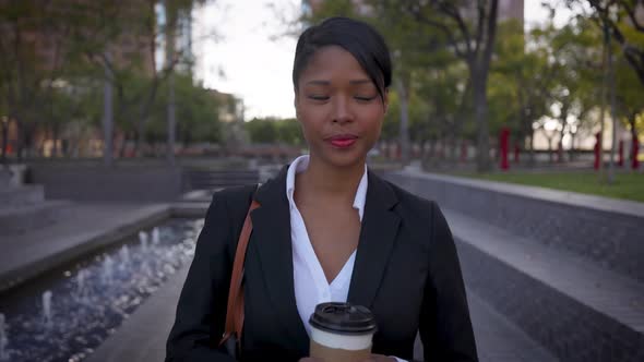 Mixed ethnicity business woman walking alt
