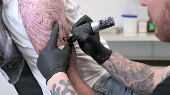 Tattoo Artist Making Tattoo at the Studio alt