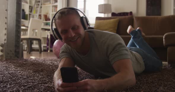 Caucasian male in social distancing listening music at home alt