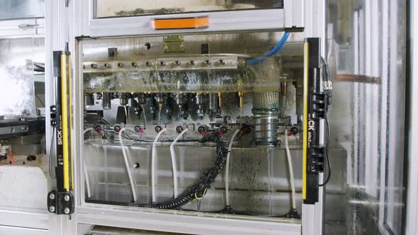 A large industrial punch press forming sheet metal parts alt