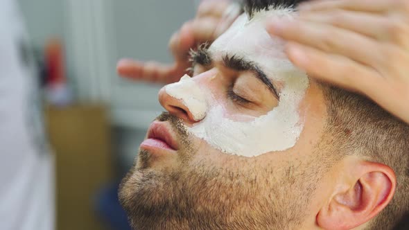 Barber Doing Face Massage and Skincare to Male Client in Barbershop