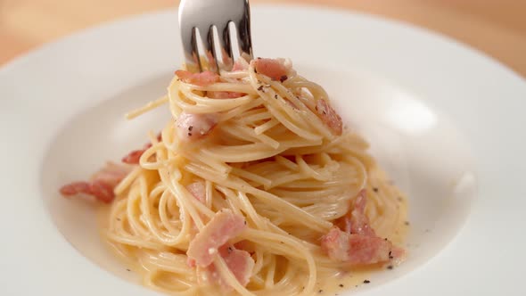 Camera follows scooping carbonara pasta from plate. Slow Motion., Stock ...