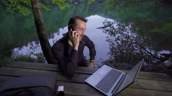 Talking on the phone in the forest. alt