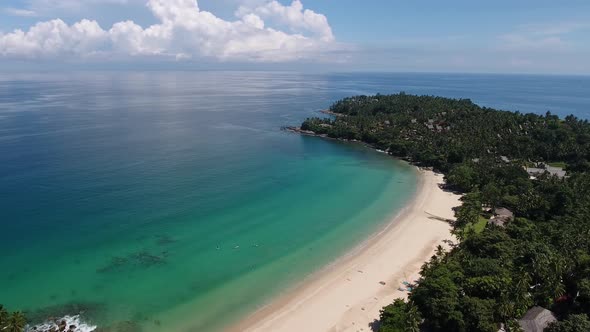 Aerial shot of Surin Beach on Phuket in Thailand, flying a part of a circle in beautiful weather alt