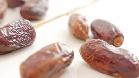 Date palm fruitexotic fruit on white background slow tilting  4K 2160p UltraHD footage - Phoenix dac alt