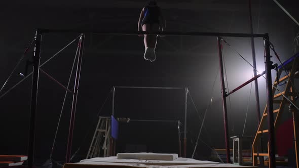 Athletic Teen Girl is Performing Tricks on Uneven Bars in Gymnastic Hall Sporty Adolescent alt