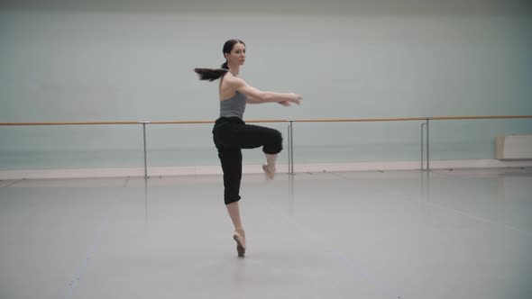 Ballerina rotates during rehearsal. Ballet dancer. Pirouette. Ballet pointe shoes. Beautiful rotate