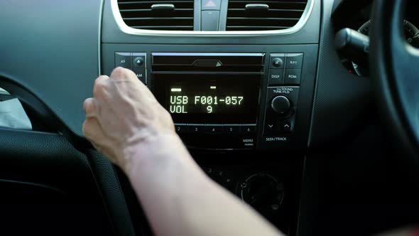 Man hand adjust music sound volume in car. audio concept