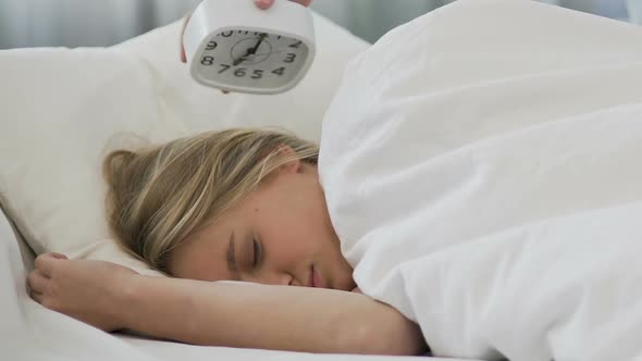 School Girl Ignoring Alarm Clock, Sleeping in Morning and Missing Lessons alt