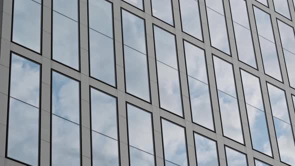 Motion Camera View of the Business District Building with Wall Mirror with Blue Cloudy Sky Reflected alt