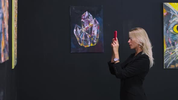 Woman is Photographing Artworks in Museum with Pictures of Modern Artist alt