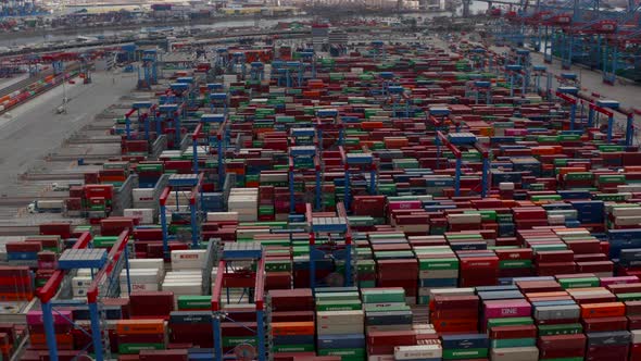 Aerial View of Multiple Automated Industrial Cranes Moving Large Cargo Containers in Hamburg Port alt