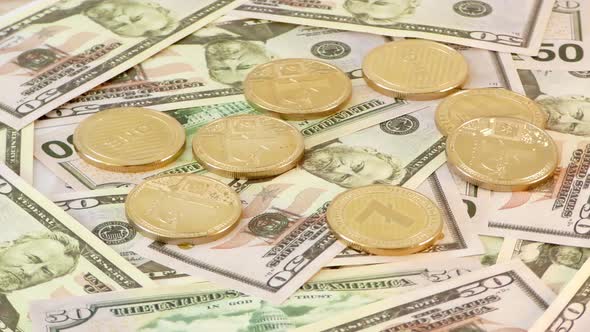Gold LightCoin LTC Coins Rotating on Bills of 50 Dollars. Worldwide Virtual Internet Cryptocurrency. alt