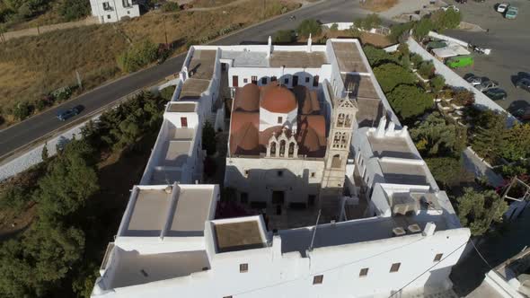 Aerial view of Agios Nikolaos church in Spetses next to a road, Greece. alt
