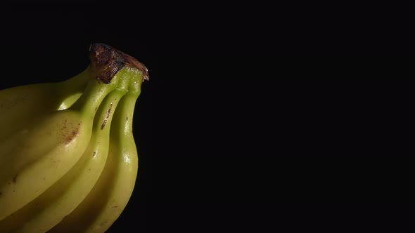 Closeup Shot of Fresh Bananas Rotating on a Turntable with a Black Background