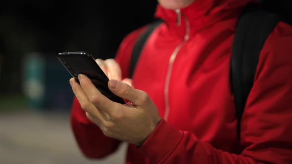 Unrecognizable Person with Smartphone in the Park