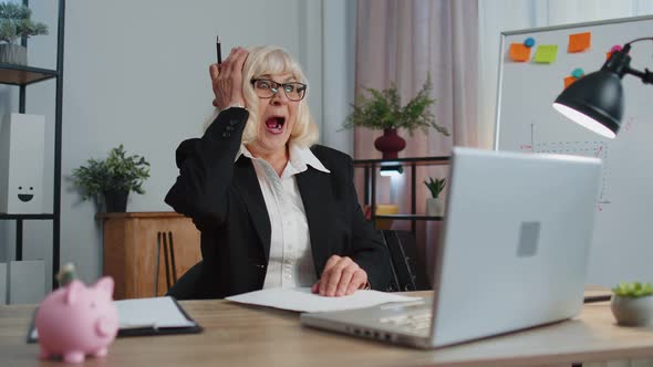 Senior Business Woman Analysing Paperwork Documents Shocked By Sudden Win Victory Good News Wow alt
