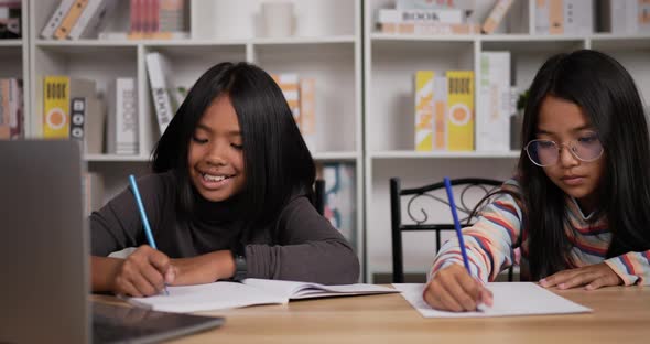Two girls learning online online at home alt