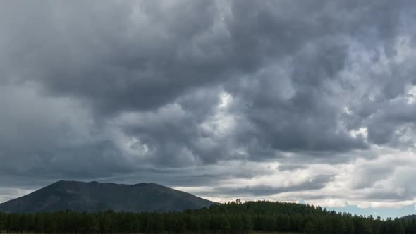 Zoom Out From Storm Clouds to Mountain Meadow alt