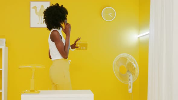 Stylish Woman Is Walking Back and Forth In Office Talking On Telephone
