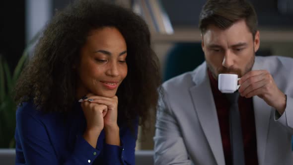 Diverse Business Partners Talking Sharing Ideas Video Calling in Coworking Cafe alt