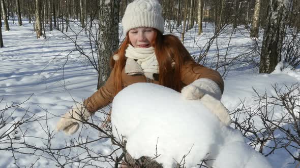 Teen-Age Child Walks At Winter Park, Red-Haired Playing With Snowy Branches.
