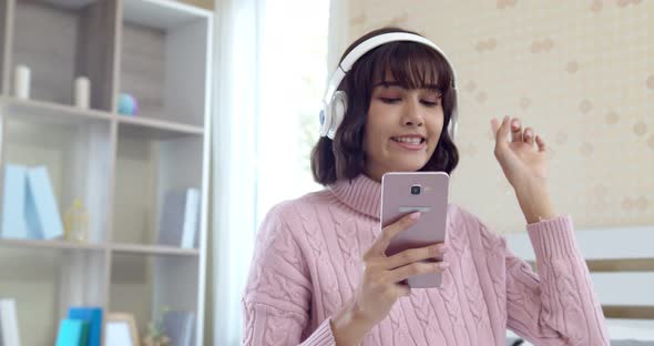 Young pretty woman enjoying with music at home alt