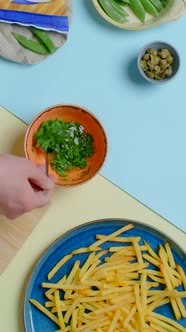 Vertical Flat Lay Video Chef Mixes Sauce with Herbs for the French Fries