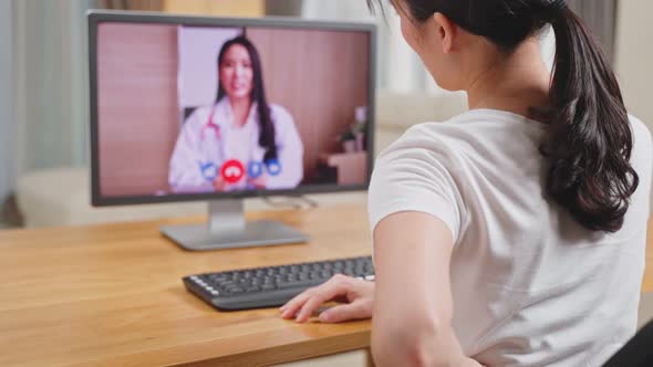 Asian woman worker consult with online virtual telemedicine doctor for medical health care in house. alt