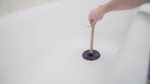 Trying to Remove a Blockage in a Bathroom Downpipe with a Plunger alt