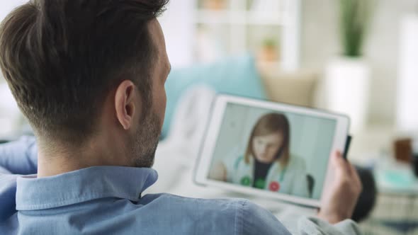 Close up of man having a video conference with doctor. Shot with RED helium camera in 8K. alt