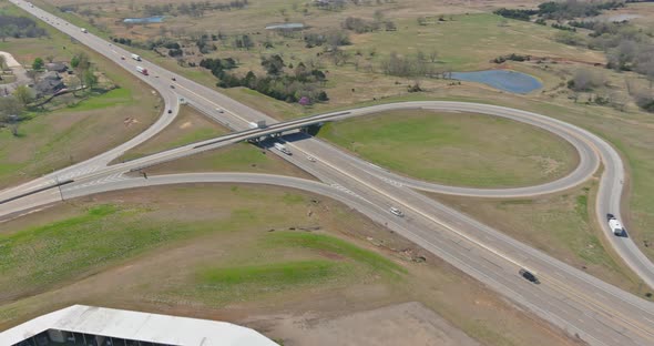 Aerial view of highway transportation with intersection crossing on a bridge in a valley alt