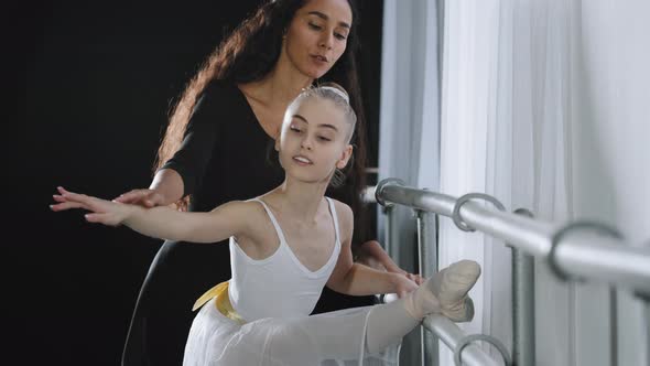 Female Choreographer Teacher Mentor Trainer of Classical Dance Teaches Posture Help with Stretching alt