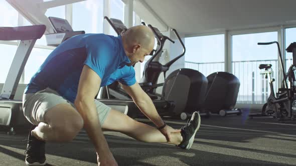 Mature Man Stretching at the Gym alt