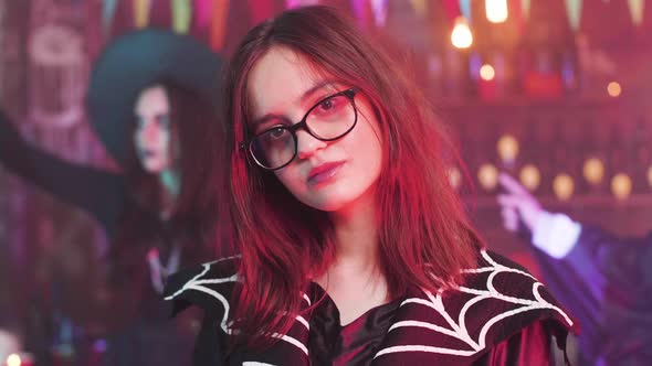 Attractive Teenage Girl in Witch Costume at Ahalloween Party alt