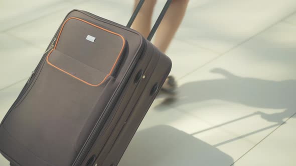 Unrecognizable Flight Attendant Walking with Travel Bag in Airport. Close-up of Suitcase in Female alt