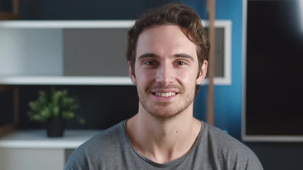 Portrait of Positive Man Face Looking Camera Enjoying Smiling Indoors in Home Office. Close-up Happy alt