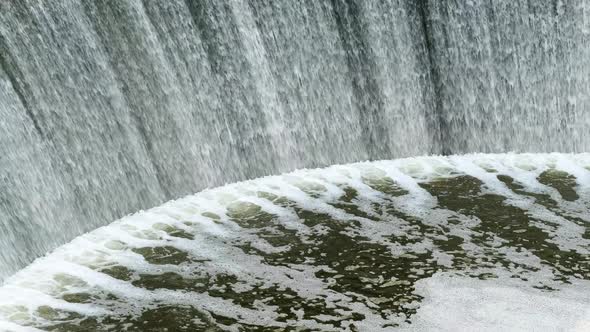 Waterfalls of Dark Water Flowing in a Powerful Stream at an Old Hydroelectric Power Station